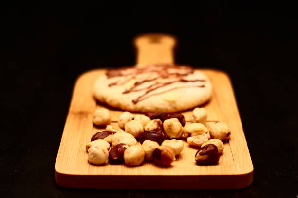 istock nut cookies and hazelnuts on a wooden board. 1129153113