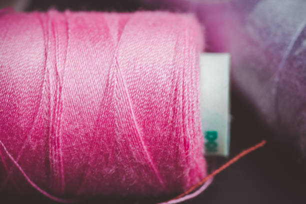 istock Color sewing threads close-up shot 1129154916