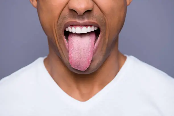 Photo of Close-up cropped portrait of his he handsome attractive well-groomed virile funky guy wearing white shirt showing tongue out isolated over gray violet purple pastel background