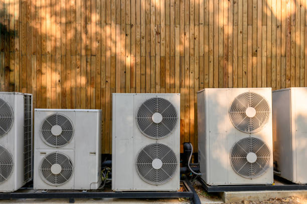 istock Many compressor air conditioning working on wooden wall 1129156526