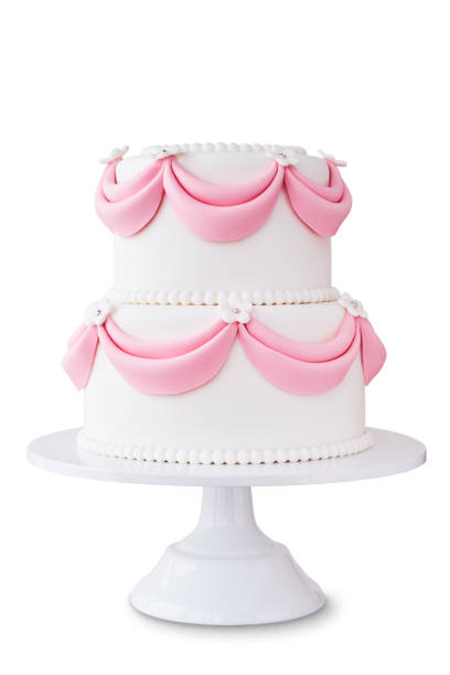 White wedding cake with pink elements made from pastry mastic isolated.
