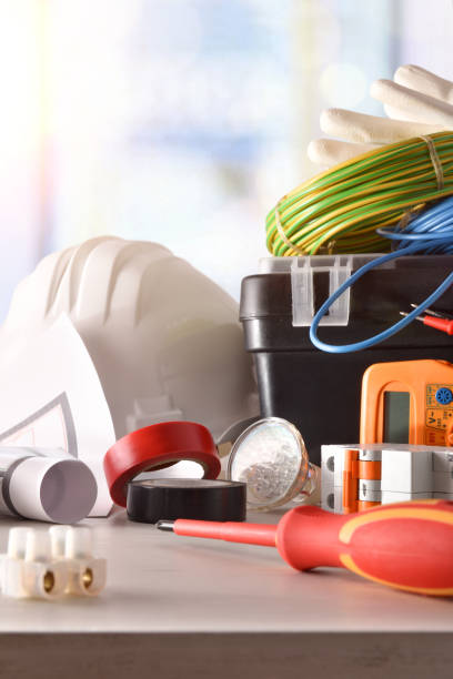 istock Electrician's office table with electrical equipment window background vertical composition 1129160885