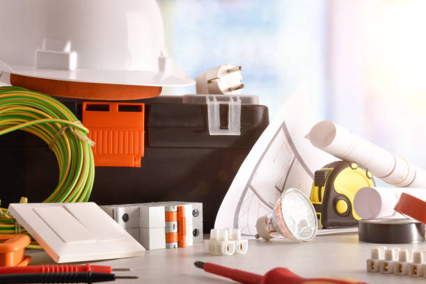 istock Electrician's office desk with electrical equipment window background front view 1129160902