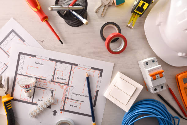 istock Office desk of electrical engineer with installation project and tools 1129160932