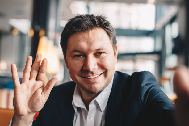 istock Close-up of good looking young man taking a selfie in a cafe bar during a break from work 1129161909