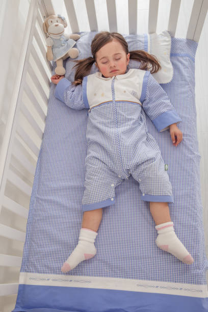 istock cute little girl sleeping in her bed 1129162092