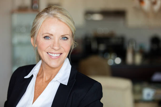 Close up of a mature lawyer smiling Close up of a mature lawyer smiling. She is calm, standing on a coffee shop saleswoman photos stock pictures, royalty-free photos & images