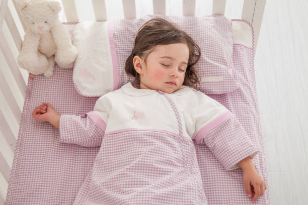 istock cute little girl sleeping in her bed 1129162146