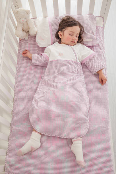 istock cute little girl sleeping in her bed 1129162152