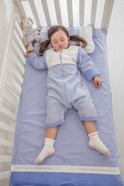 istock cute little girl sleeping in her bed 1129162154