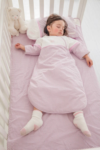 istock cute little girl sleeping in her bed 1129162191