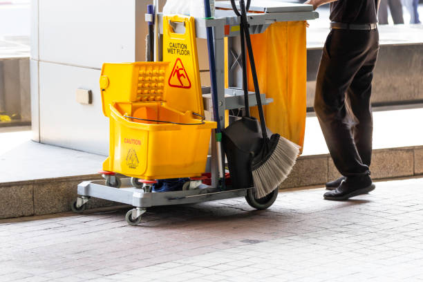 istock Janitorial and mop bucket on cleaning in process and worker on work. 1129162570