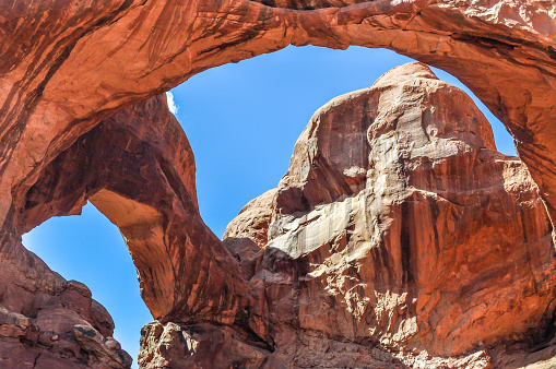 Double O Arch towers high above the landscape in Arches National Park of Utah.