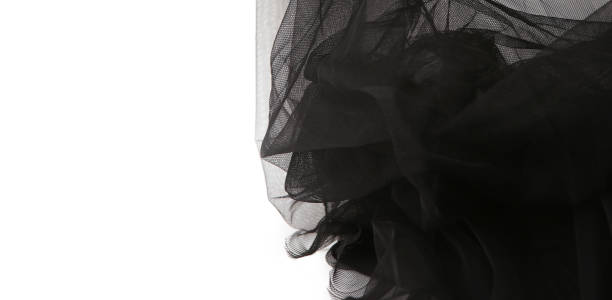 istock Abstract composition of black tulle material  isolated on white background. 1129164484