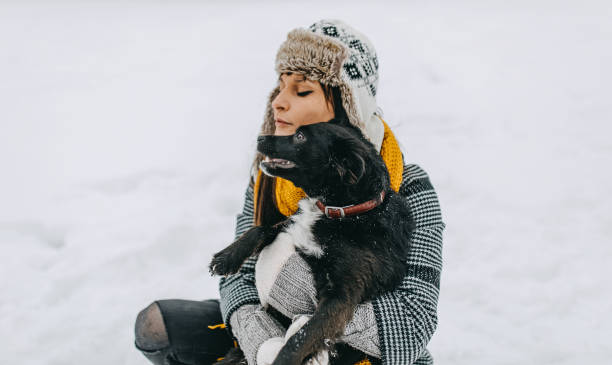 istock Young woman playing with dog 1129165678