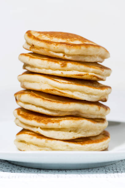 istock stack of delicious pancakes on a plate, vertical closeup 1129167873