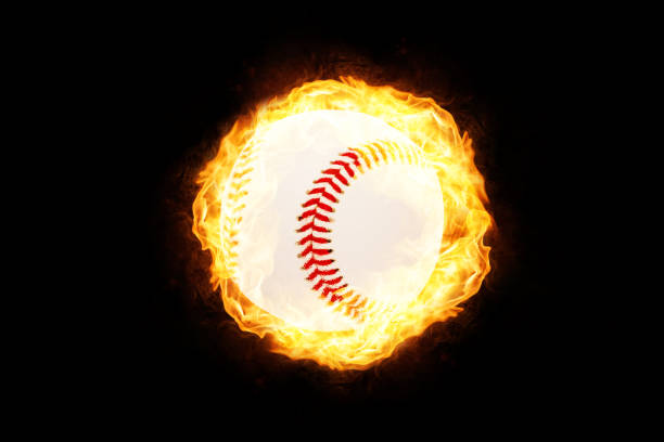 istock Baseball in Fire isolated on Black Background 1129168606
