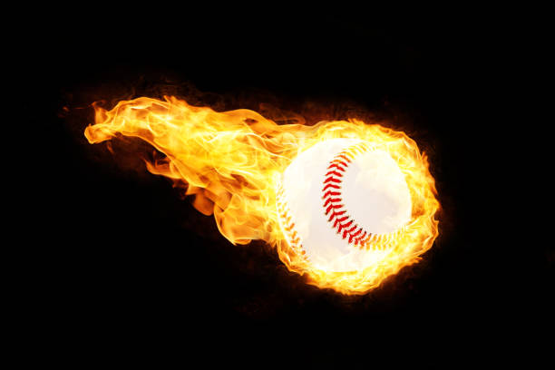 istock Baseball in Fire isolated on Black Background 1129168655