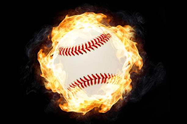 istock Baseball in Fire isolated on Black Background 1129168752