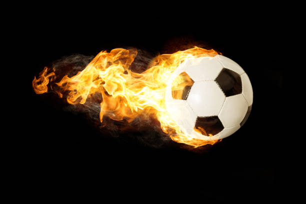 istock Soccer Ball in Fire isolated on Black Background 1129168779