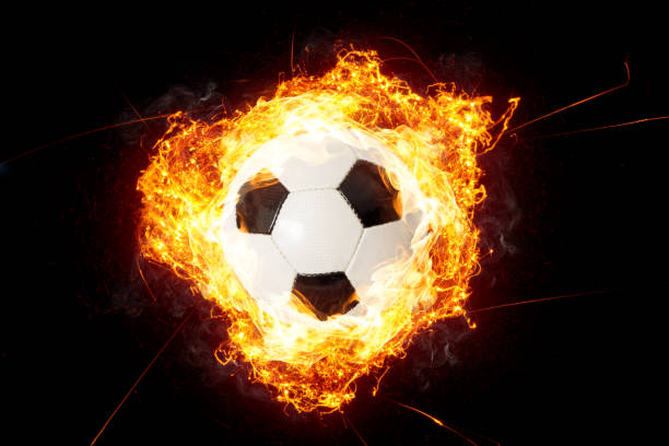 istock Soccer Ball in Fire isolated on Black Background 1129168780