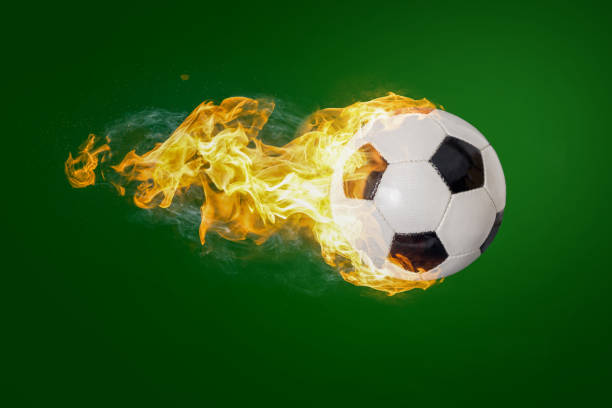 istock Soccer Ball in Fire isolated on Black Background 1129169104