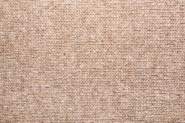 istock Abstract beige knitted fabric for background.Knitted texture. 1129170002