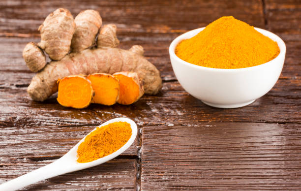istock Fresh organic root and turmeric powder - Curcuma longa 1129170543