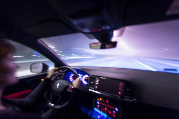 istock woman is driving a car at night 1129170953