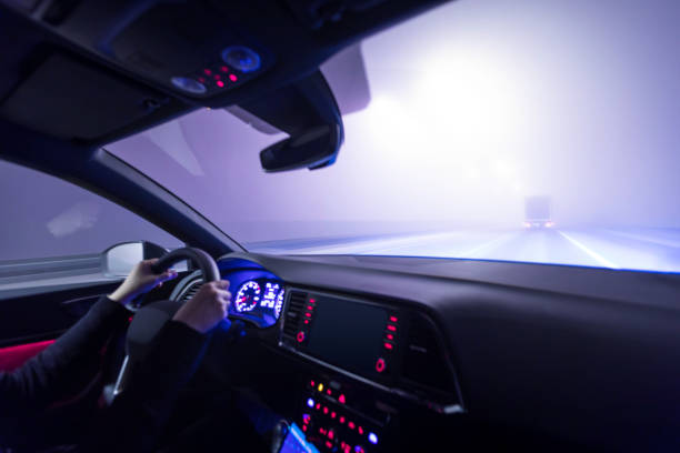 istock woman is driving a car at night 1129170954