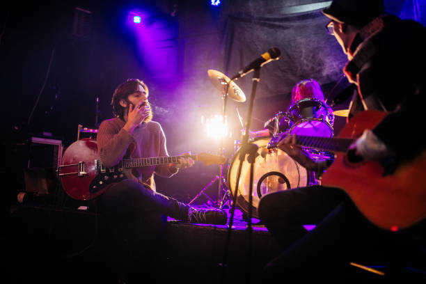 istock Rock band playing at a nightclub 1129170995