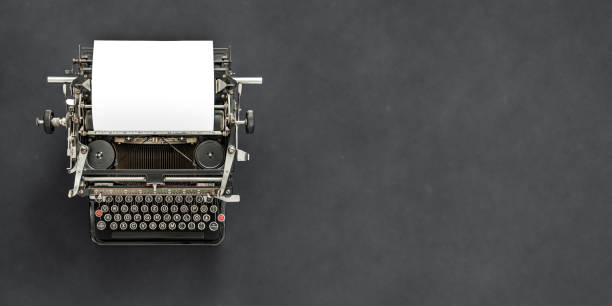istock Vintage typewriter with blank sheet of paper retro technology 1129173535
