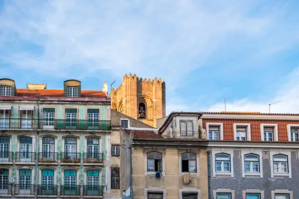 Photo of Street view of Lisbon Alfama neighbourhood with SÃ© cathedral tower