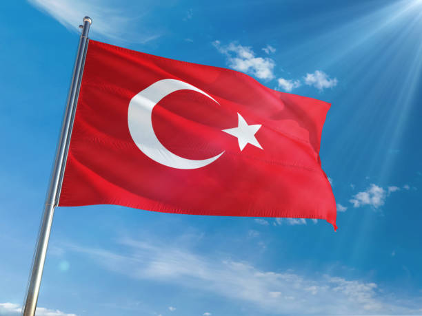 istock Turkey National Flag Waving on pole against sunny blue sky background. High Definition 1129173693