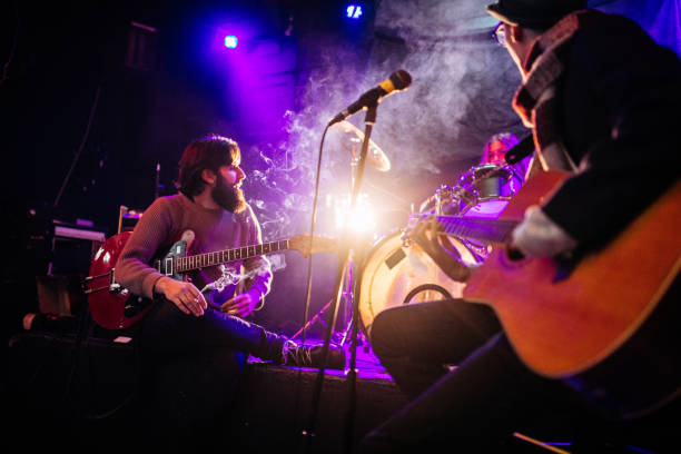 istock Rock band playing at a nightclub 1129173713