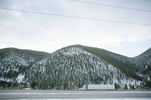 istock Semi Tractor Trailer Truck on a Snowy Mountain Highway 1129174029