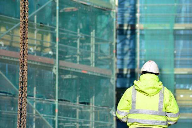 istock Back view of male engineer standing on construction site 1129174665