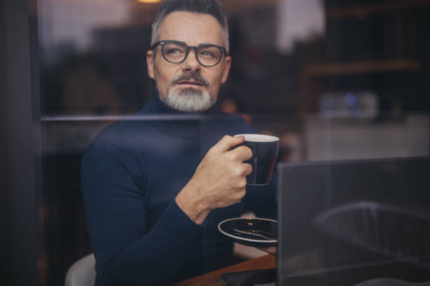 istock Mature man in the coffee shop 1129174945