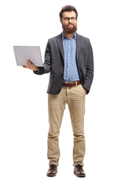 istock Man standing with a laptop and smiling at the camera 1129176418