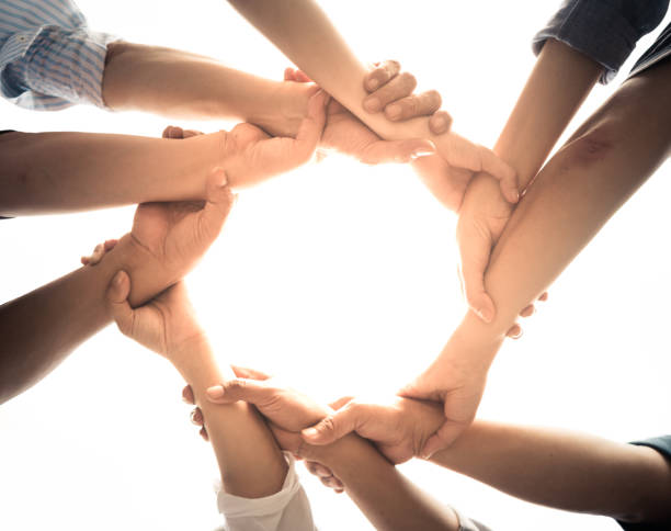 istock Close up of teamwork holding hands 1129176622