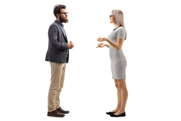 istock Man and woman standing and talking 1129177153