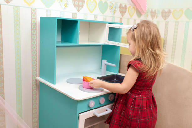 istock baby cooks on a toy stove 1129178164