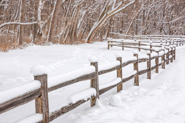istock Wooden fence covered in fresh white fluffy snow. 1129179237