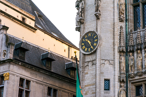 Clock on the facade of the house on the square Grand Place in the center of Brussels.Brussels, Belgium. details Of the facade of the houses on the Grand place and the Maison du Roi historic squares and sights of Brussels.