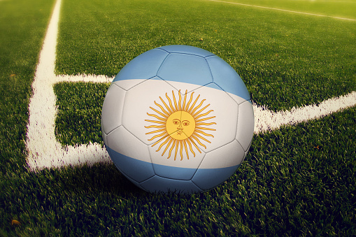 Argentina ball on corner kick position, soccer field background. National football theme on green grass.
