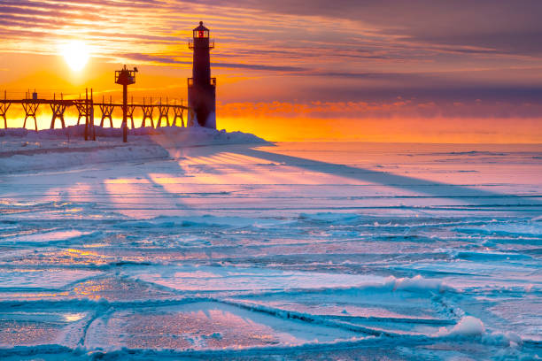 istock Breathtaking sunrise casts long shadows across cold, icy harbor. 1129179629