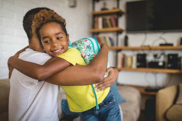 istock Cheerful child embracing her father before school 1129179917