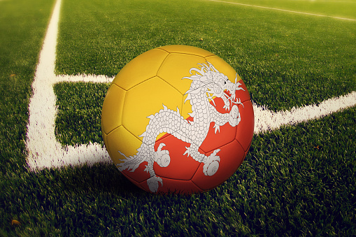 Bhutan ball on corner kick position, soccer field background. National football theme on green grass.