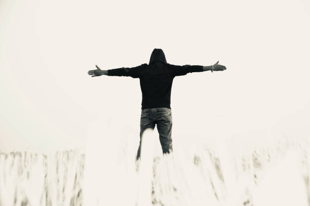 istock Man wearing black dress raising the hands 1129181056