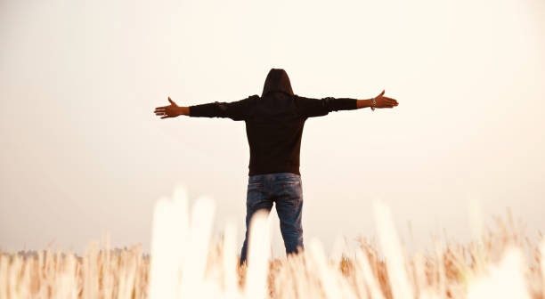 Man wearing black dress raising the hands